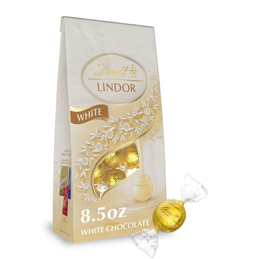 Experience the ultimate white chocolate indulgence with Lindt LINDOR White Chocolate Truffles. Surprise someone special with a white chocolate candy gift, or share one of these Lindt LINDOR Chocolate Truffles as a sweet, indulgent after-dinner treat. With a delicate white chocolate shell and a luscious, smooth melting white truffle center, this truffle proves that white chocolate has never been so creamy and indulgent. When you break the shell, the truffle's smooth, luscious center begins to melt and so wil