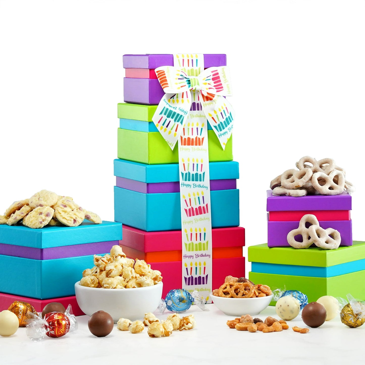 Surprise a friend, coworker of family member with this delicious and colorful Broadway Basketeers Happy Birthday Wishes Gift Tower. This decadent includes four boxes full of sweet and salty treats, including gourmet seasoned popcorn, chocolate toffee pretzels, jelly beans, nuts and more. The gourmet gift tower is Kosher Certified, for effortless gifting. The boxes are stacked and wrapped with a Happy Birthday ribbon for a sweet, artful presentation.