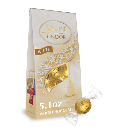 Experience the ultimate white chocolate indulgence with Lindt LINDOR White Chocolate Truffles. Surprise someone special with a white chocolate candy gift, or share one of these Lindt LINDOR Chocolate Truffles as a sweet, indulgent after-dinner treat. With a delicate white chocolate shell and a luscious, smooth melting white truffle center, this truffle proves that white chocolate has never been so creamy and indulgent. When you break the shell, the truffle's smooth, luscious center begins to melt and so wil